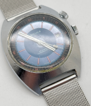 A vintage stainless steel cased men's wrist watch by Sicura. Blue face with red and white hour