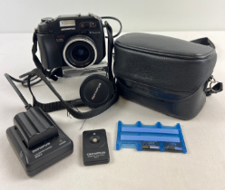 An Olympus Camedia C-5060 5.1 Megapixel Wide Zoom lens camera with neck strap, carry case, 3 x