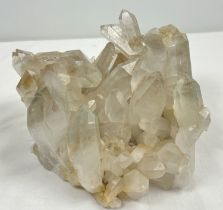 A large 4.45kg natural clear quartz cluster with natural brown/orange inclusions throughout. Many