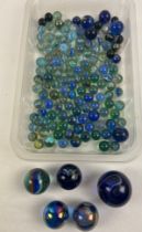 A collection of vintage glass marbles in black and blue colours. To include cats eye, Oillies and