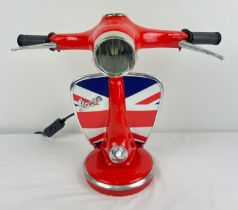 A novelty table lamp in the shape of the handlebars of a Vespa scooter, painted red with Union