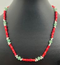 An 18"costume jewellery necklace of coral/sea bamboo and aventurine beads with silver tone S