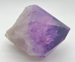 A large natural amethyst point. Rainbow inclusions visible. Approx. 9cm x 16cm.