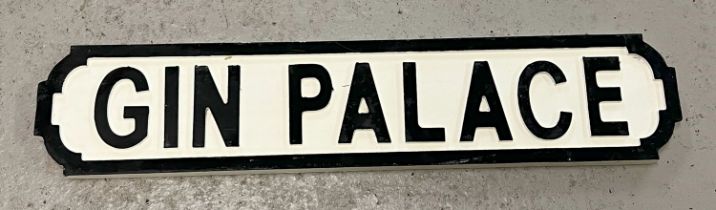 A modern painted wood 'Gin Palace' sign, in the style of an old street sign. Approx. 65cm long.