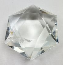 A 1.1 kg cut and polished natural clear quartz star with natural inclusions and rainbow reflections.