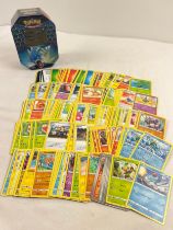 225 assorted Pokemon cards in a 2019 Pokemon - GX Gyarados Hidden Fates octagonal shaped tin.