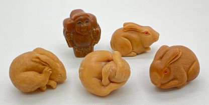 A collection of 5 small carved resin figures/netsukes, 3 modelled as rabbits. 3 have small holes for