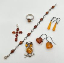 A collection of vintage silver & white metal jewellery set with amber. To include a brooch
