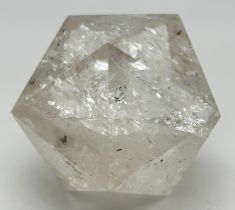 A cut and polished clear quartz icosahedron with natural galaxies and rainbow reflections. Approx.