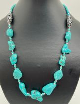 A 20" costume jewellery necklace of chunky turquoise beads with silver coloured bead detail.