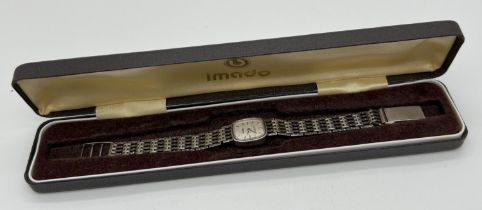 A boxed ladies vintage silver wristwatch by Imado. 5 bar gate style strap with silver marks to