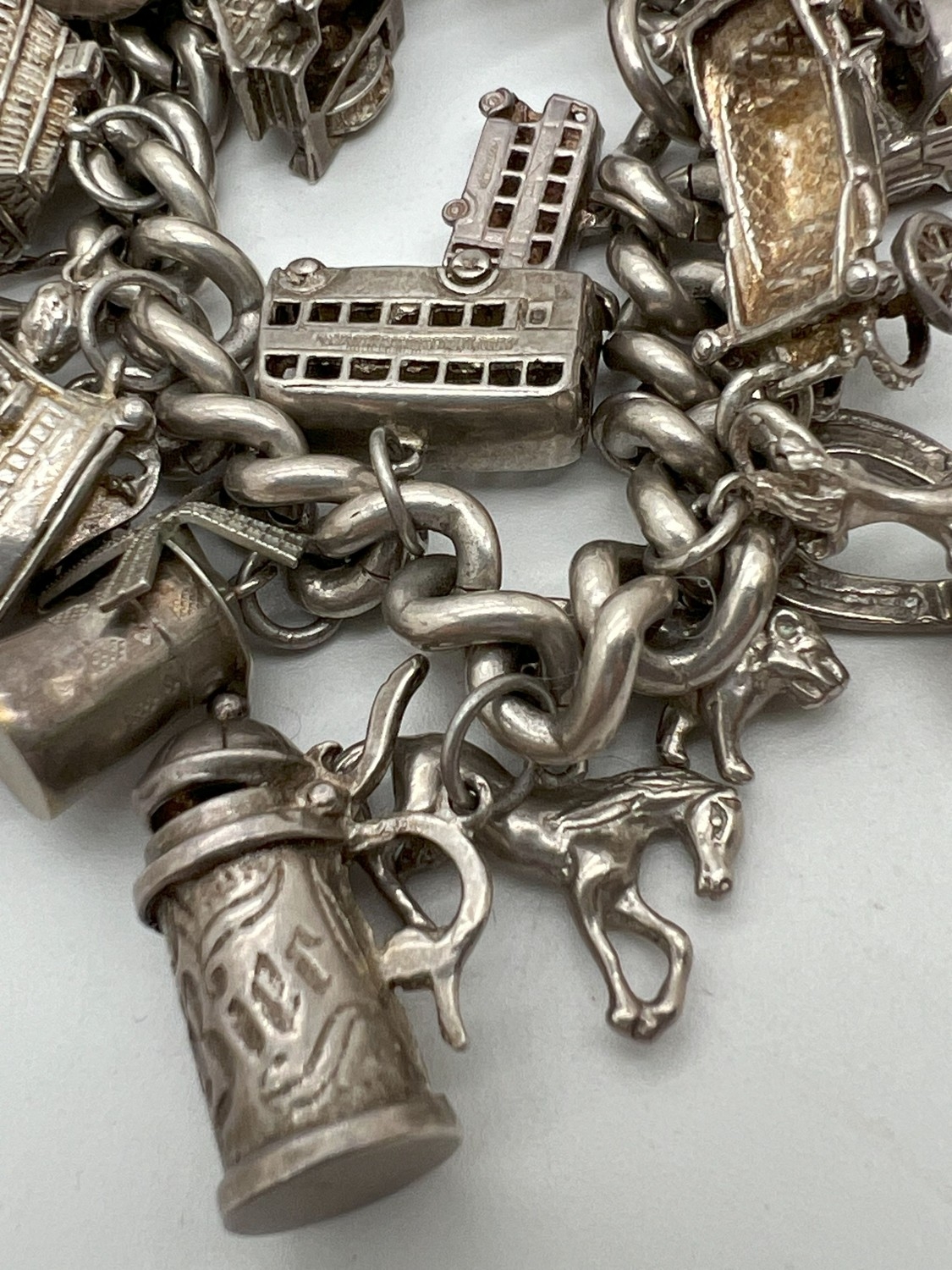 A vintage silver charm bracelet with large padlock clasp and 29 silver and white charms - some - Image 3 of 8