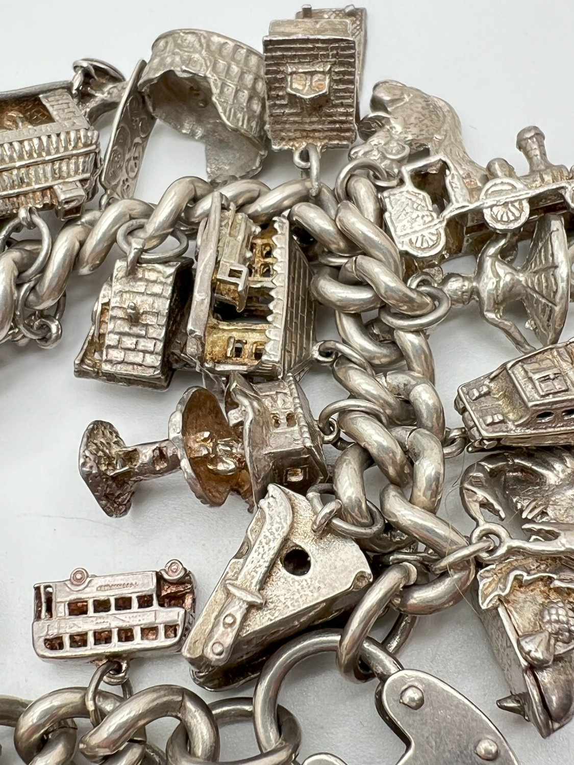 A vintage silver charm bracelet with large padlock clasp and 29 silver and white charms - some - Image 7 of 8