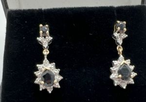 A pair of 9ct gold sapphire and diamond drop style earrings. Diamond illusion set teardrop cut