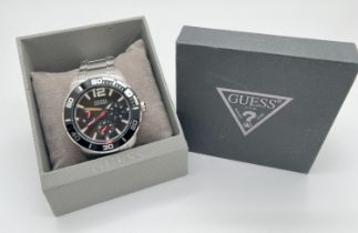 A boxed ex shop stock Men's chronograph wristwatch by Guess. Stainless steel case and strap. Black