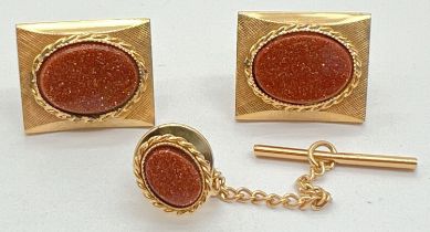 A vintage pair of goldtone cufflinks set with ovals of brown goldstone, together with a matching tie