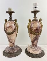 A pair of heavy 19th century French marble and cast metal urn style table lamps. Cherub and swag