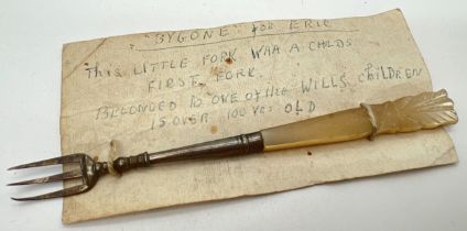 An antique mother of pearl handled child's fork with accompanying hand written card. Approx. 12.75cm