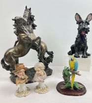A collection of assorted ceramic and resin ornaments to include a large resin figurine of rearing