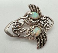 A 925 silver Art Nouveau design brooch with pierced work detail, set with opals. Approx. 3.5cm long.