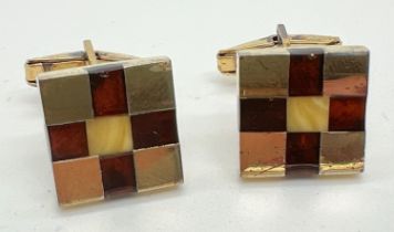 A pair of gold on silver chequerboard design cufflinks set with squares of honey & cognac amber.