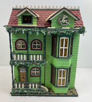 A Compton & Woodhouse battery operated 'Musical Dolls House' with lights and sounds. Lights up,