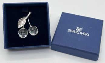 A boxed Swarovski brooch modelled as cherries with 2 multi faceted clear crystal drops. Stamped with