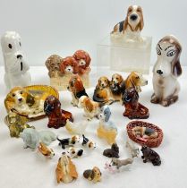 A collection of ceramic, metal, natural stone and resin figures of mostly Basset hounds in varying