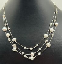 A 17 inch triple strand silver box chain, bead and freshwater pearl necklace with lobster clasp