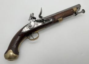 An antique Tower Naval.58 caliber flintlock pistol. Wooden stock with brass trigger and butt
