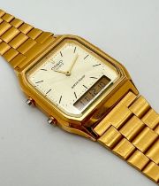 A Casio AQ-230 quartz and digital display watch with stainless steel gold tone strap and case. Casio