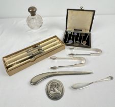 An early 20th century silver topped perfume bottle together with a collection of assorted silver