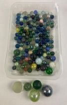 A collection of vintage marbles in varying design and sizes to include speckled glass, end of day