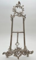 A modern nickel metal Regency style table top easel book/picture stand with hinged foot. Approx.