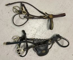 2 vintage leather, brass and metal horse bridal and bits. One with eye blinkers.