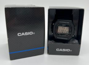 A boxed Casio Illuminator W-218H digital wristwatch with hard plastic case and rubber strap. With
