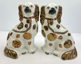 A pair of vintage ceramic Staffordshire style dog figurines with bronze lustre finish. Holes to