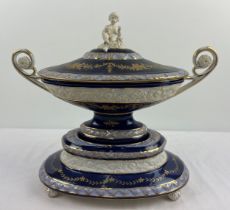 A large Continental ceramic centrepiece lidded tureen with cobalt blue banded glaze and bisque