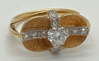 A bespoke made contemporary design yellow gold dress ring with white gold illusion cross over