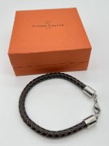 A boxed Simon Carter men's plaited brown leather bracelet with stainless steel lobster style clasp