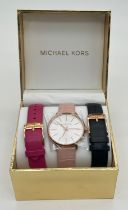 A brand new in box ladies wristwatch with interchangeable straps by Michael Kors. Gold tone case