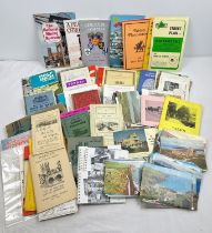 A box of assorted vintage ephemera to include British maps, tourist guides and postcards.