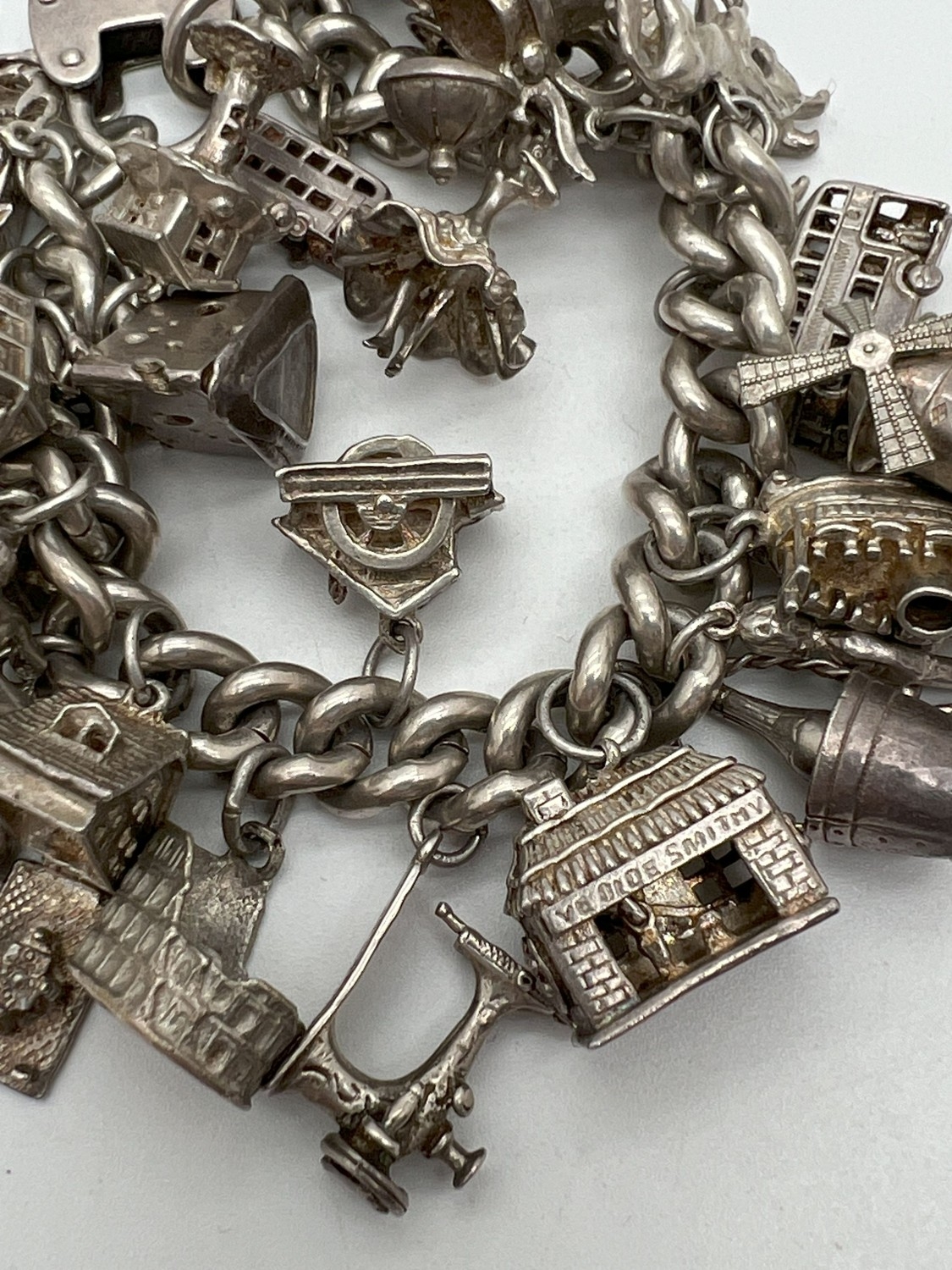 A vintage silver charm bracelet with large padlock clasp and 29 silver and white charms - some - Image 5 of 8