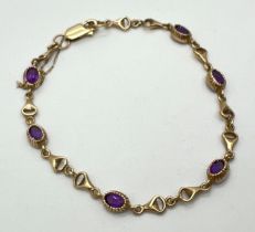 A 9ct gold and amethyst set bracelet with horse bit style links, safety chain and lobster claw