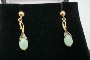 A boxed pair of 9ct gold green jade and diamond drop style earrings, no butterfly backs. Each