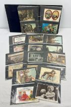 An album containing 100+ assorted vintage postcards and greetings cards, to include animals, trains,