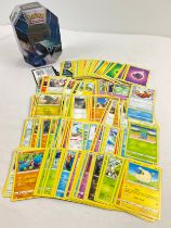 226 assorted Pokemon cards in a 2021 Pokemon V Empoleon octagonal shaped tin. Cards comprise 201