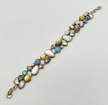 A modern design 8" silver bracelet set with multiple coloured and sized shell pieces, to include