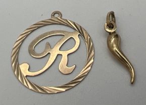 2 gold pendants. A small Horn of Hope together with a circular pendant with initial R to centre.