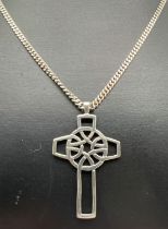 An openwork Celtic style cross pendant on an 18" curb chain with spring ring clasp. Silver marks